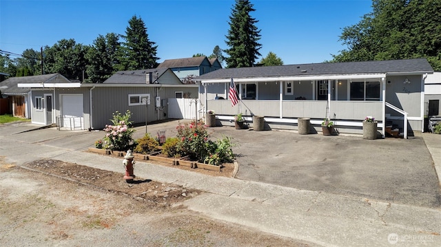 207 6th St, Sultan, WA 98294 - view of front of property featuring covered porch, a garage, concrete driveway, and an outdoor structure