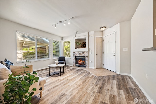 11130 SE 208th St Unit N101, Kent, WA 98031 - living area featuring wood finished floors, a fireplace, and track lighting