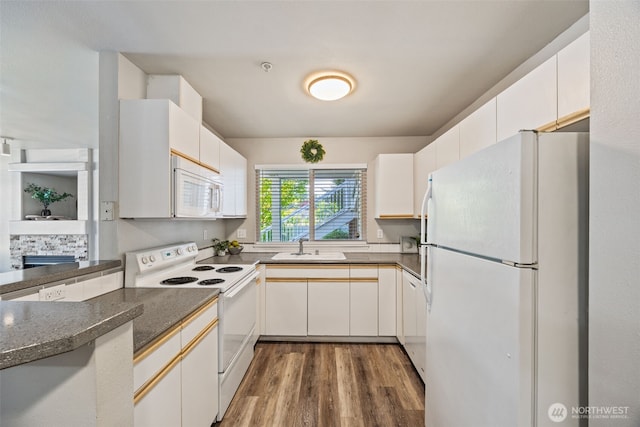 11130 SE 208th St Unit N101, Kent, WA 98031 - kitchen with white appliances and wood finished floors
