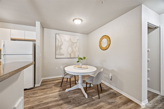 11130 SE 208th St Unit N101, Kent, WA 98031 - dining area featuring wood finished floors and baseboards