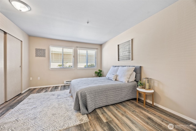 11130 SE 208th St Unit N101, Kent, WA 98031 - bedroom featuring baseboard heating and wood finished floors