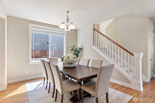 2648 116th Ave NE, Bellevue, WA 98004 - dining area featuring a chandelier, light wood finished floors, and stairway