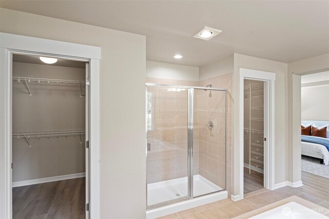 2648 116th Ave NE, Bellevue, WA 98004 - full bathroom featuring a walk in closet, a stall shower, and ensuite bath