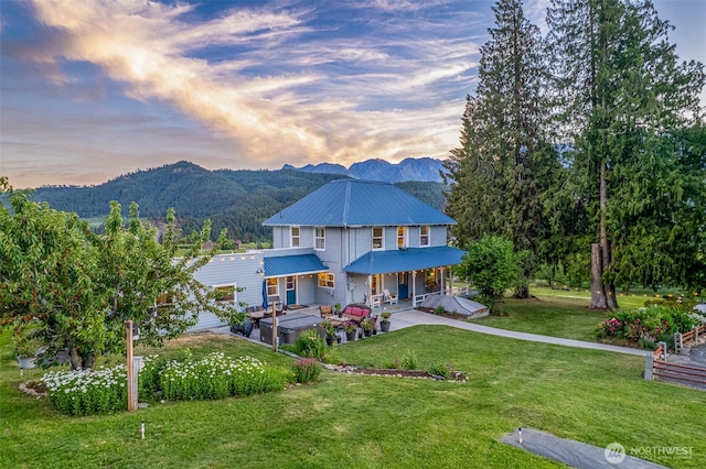 9753 Nibbelink Rd, Peshastin, WA 98847 - view of front of home featuring a mountain view, a metal roof, a yard, and a patio area