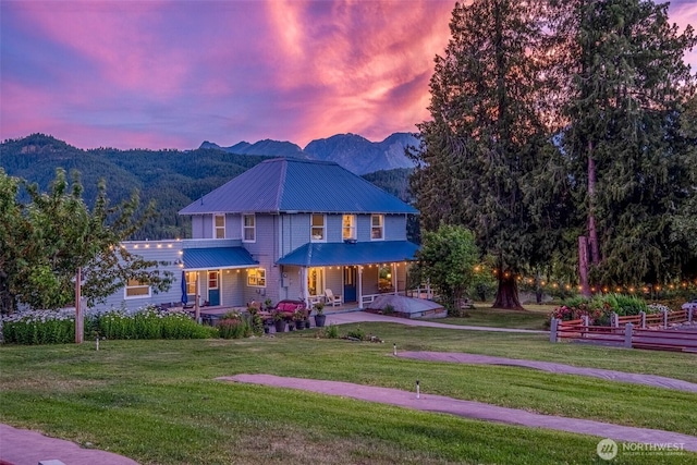 9753 Nibbelink Rd, Peshastin, WA 98847 - view of front facade with a porch, a mountain view, a front yard, and a metal roof