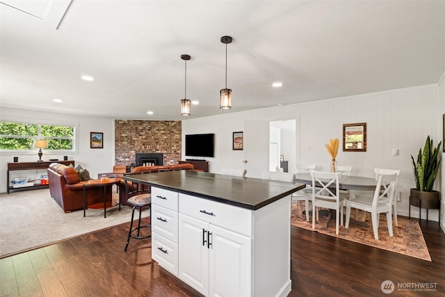 9753 Nibbelink Rd, Peshastin, WA 98847 - kitchen with dark countertops, open floor plan, dark wood-style flooring, white cabinets, and pendant lighting