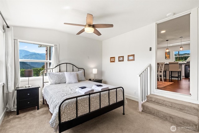 9753 Nibbelink Rd, Peshastin, WA 98847 - bedroom with light colored carpet, a mountain view, and a ceiling fan