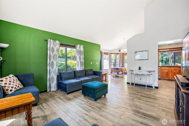9304 Farwest Dr SW, Tacoma, WA 98498 - living room featuring light wood-style floors, high vaulted ceiling, plenty of natural light, and a chandelier