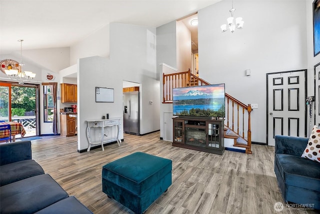 9304 Farwest Dr SW, Tacoma, WA 98498 - living room with a chandelier, high vaulted ceiling, stairs, and light wood-style flooring