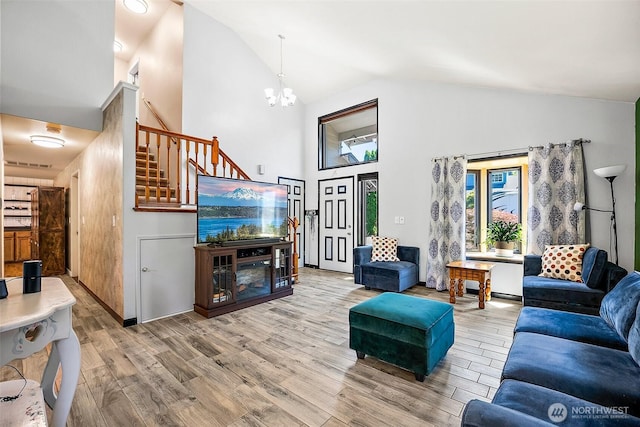 9304 Farwest Dr SW, Tacoma, WA 98498 - living room featuring high vaulted ceiling, wood finished floors, stairway, and a chandelier