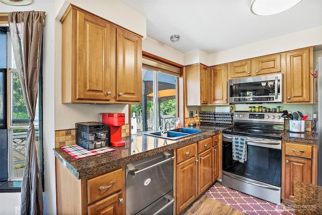 9304 Farwest Dr SW, Tacoma, WA 98498 - kitchen with stainless steel appliances, tile counters, brown cabinets, and wood finished floors