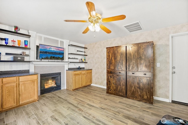 9304 Farwest Dr SW, Tacoma, WA 98498 - living room with light wood finished floors, a ceiling fan, and a glass covered fireplace