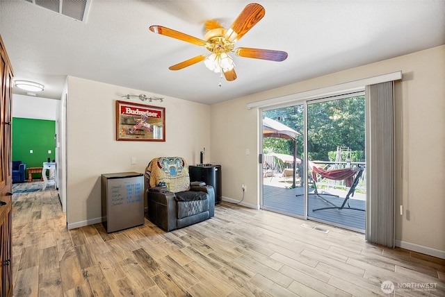 9304 Farwest Dr SW, Tacoma, WA 98498 - sitting room with light wood-style flooring and a ceiling fan