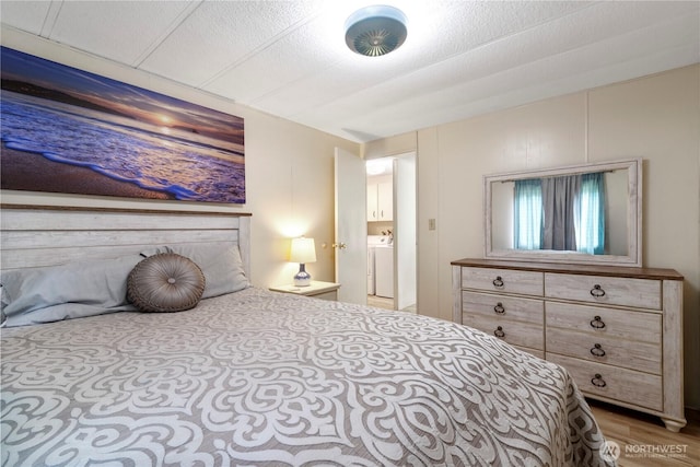1402 301st Pl, Ocean Park, WA 98640 - bedroom with light wood-type flooring and washer / dryer