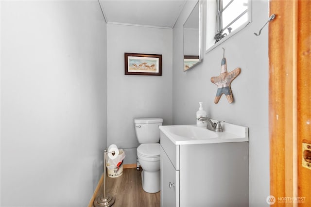 1402 301st Pl, Ocean Park, WA 98640 - half bath featuring vanity, wood finished floors, and ornamental molding