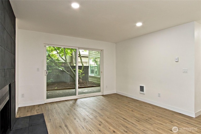 11811 93rd Ln NE Unit 102, Kirkland, WA 98034 - unfurnished living room with a fireplace, wood finished floors, and recessed lighting