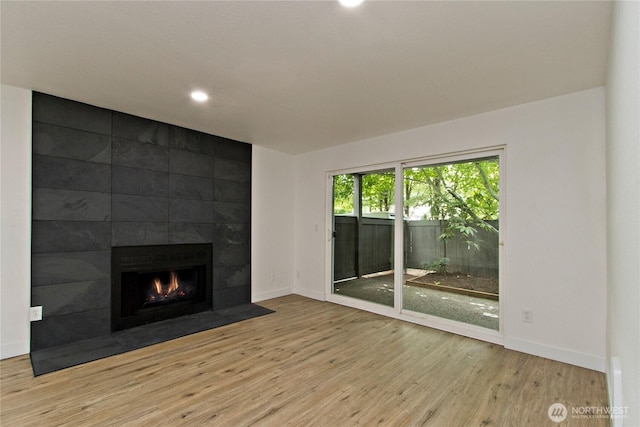 11811 93rd Ln NE Unit 102, Kirkland, WA 98034 - unfurnished living room with wood finished floors, a fireplace, and recessed lighting