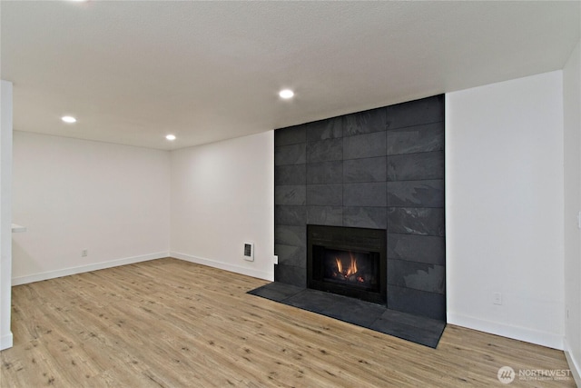 11811 93rd Ln NE Unit 102, Kirkland, WA 98034 - unfurnished living room with wood finished floors, recessed lighting, and a fireplace
