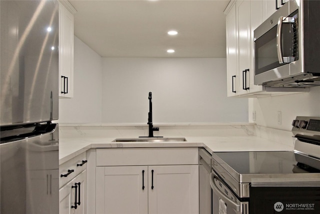 11811 93rd Ln NE Unit 102, Kirkland, WA 98034 - kitchen featuring appliances with stainless steel finishes, recessed lighting, and white cabinets