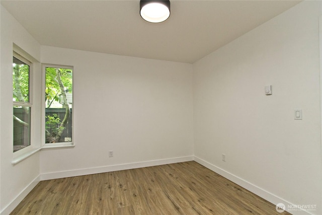 11811 93rd Ln NE Unit 102, Kirkland, WA 98034 - spare room with wood finished floors and baseboards