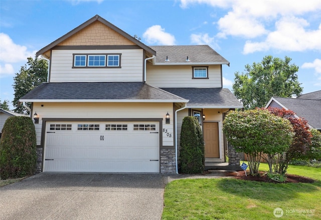 8305 54th Ct SE, Lacey, WA 98513 - craftsman house featuring driveway, a shingled roof, a front lawn, an attached garage, and stone siding