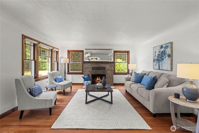 34226 42nd Ave S, Auburn, WA 98001 - living room featuring wood finished floors, a warm lit fireplace, and a textured ceiling