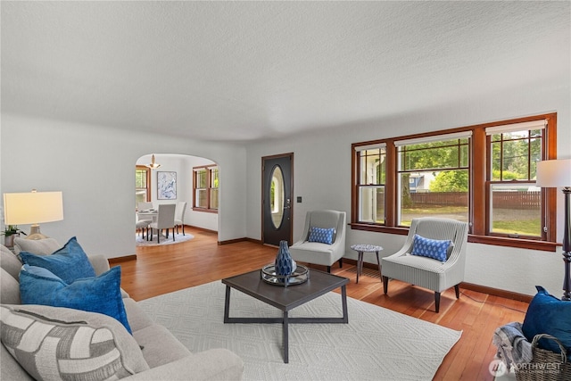 34226 42nd Ave S, Auburn, WA 98001 - living room with arched walkways, wood finished floors, and a textured ceiling