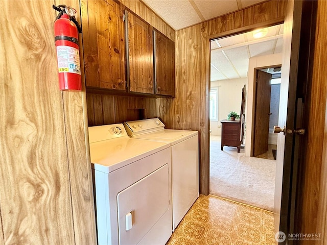 1519 Alonda Ln NE, Olympia, WA 98516 - laundry area with cabinet space, washing machine and clothes dryer, wood walls, and light carpet