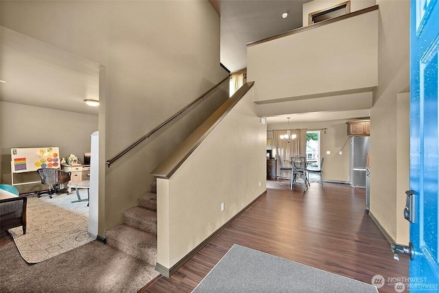 16908 61st St NW, Vaughn, WA 98394 - foyer featuring wood finished floors, a chandelier, stairs, and a towering ceiling