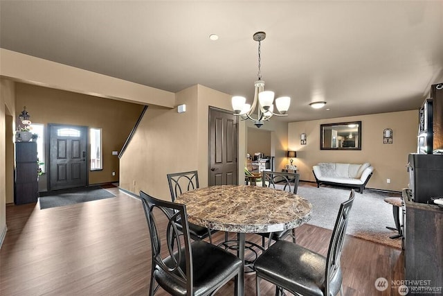 16908 61st St NW, Vaughn, WA 98394 - dining area featuring wood finished floors and a chandelier