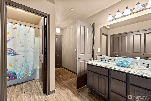 16908 61st St NW, Vaughn, WA 98394 - bathroom with double vanity, wood finished floors, and shower / tub combo with curtain