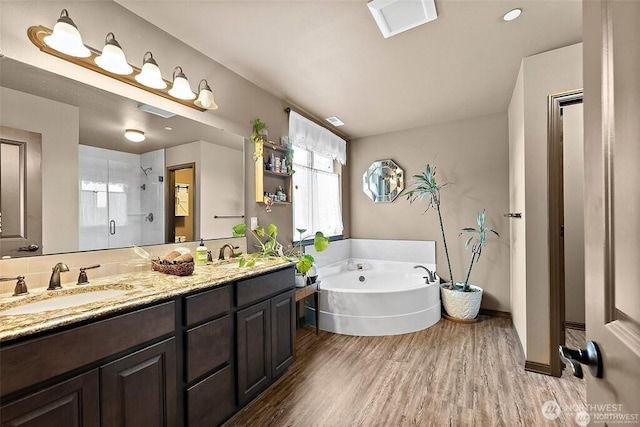 16908 61st St NW, Vaughn, WA 98394 - full bathroom with a shower stall, wood finished floors, double vanity, and a garden tub