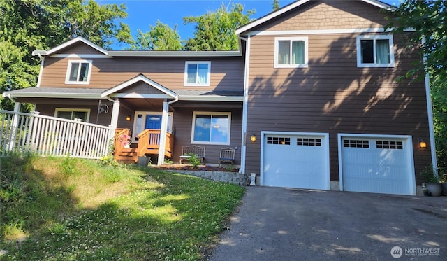 16908 61st St NW, Vaughn, WA 98394 - view of front facade featuring asphalt driveway, a porch, and a garage