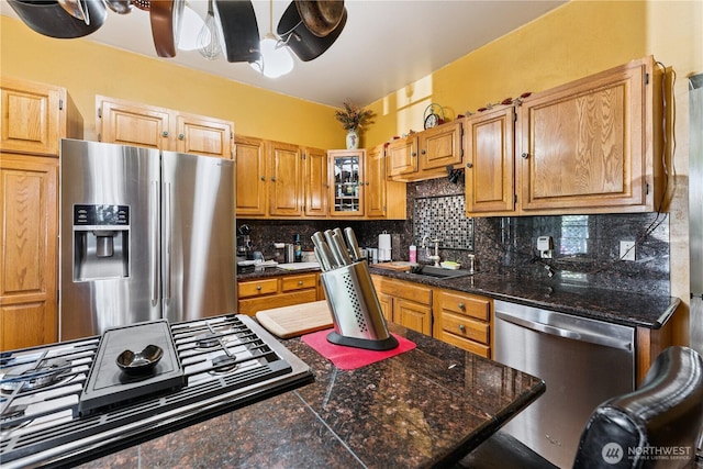 701 13th St SE, Puyallup, WA 98372 - kitchen with stainless steel appliances, decorative backsplash, a ceiling fan, tile counters, and glass insert cabinets