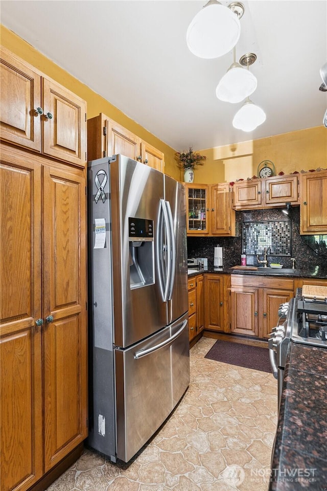 701 13th St SE, Puyallup, WA 98372 - kitchen with appliances with stainless steel finishes, brown cabinets, backsplash, and dark countertops