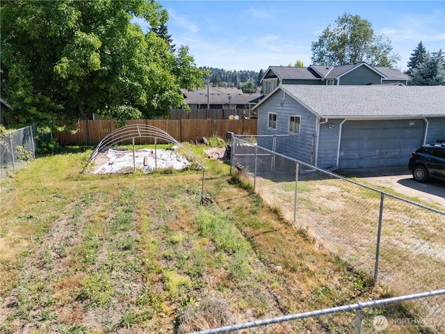 701 13th St SE, Puyallup, WA 98372 - fenced backyard with a garage and driveway