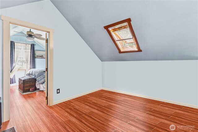 701 13th St SE, Puyallup, WA 98372 - additional living space featuring vaulted ceiling, a skylight, wood finished floors, and ceiling fan