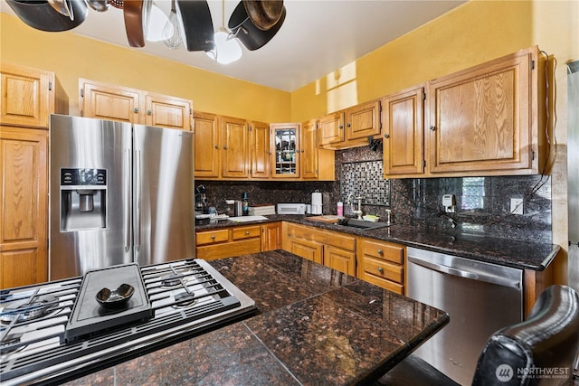 701 13th St SE, Puyallup, WA 98372 - kitchen featuring appliances with stainless steel finishes, tile counters, backsplash, ceiling fan, and glass insert cabinets