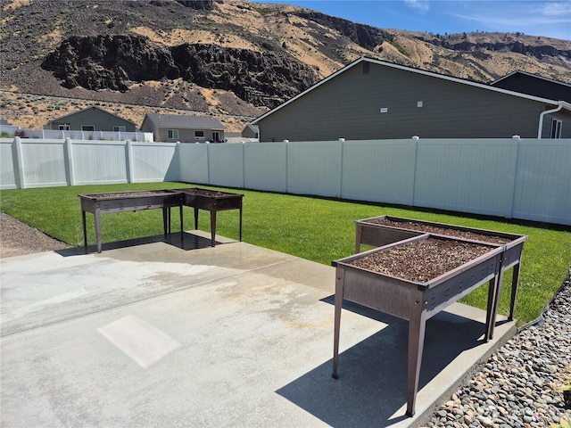 420 Hammond Ln, Rock Island, WA 98850 - fenced backyard featuring a patio area, a mountain view, and a vegetable garden
