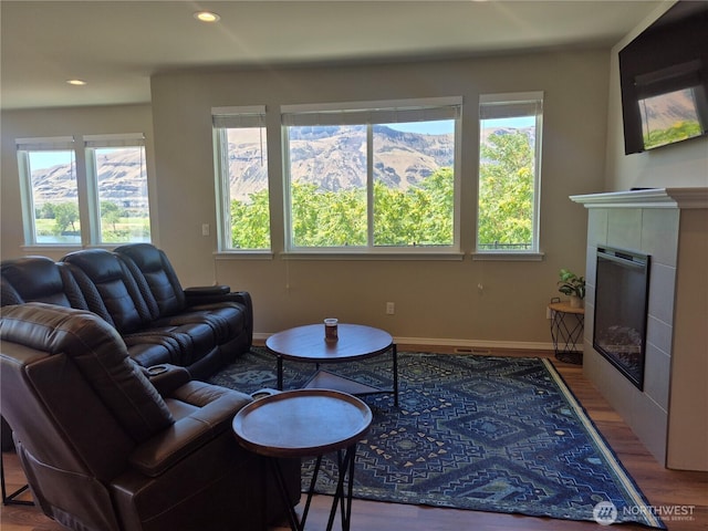 420 Hammond Ln, Rock Island, WA 98850 - living room featuring wood finished floors, healthy amount of natural light, recessed lighting, and a tile fireplace