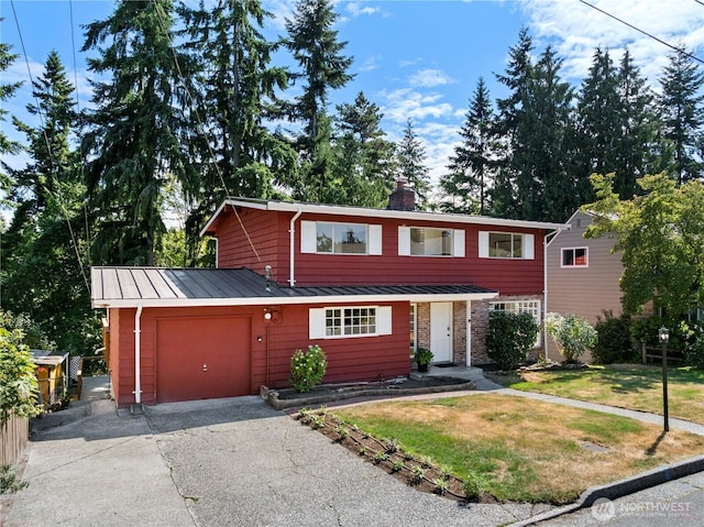 317NW 177th St, Shoreline, WA 98177 - view of front of house featuring a standing seam roof, asphalt driveway, an attached garage, a front yard, and a chimney