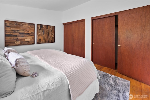 317NW 177th St, Shoreline, WA 98177 - bedroom featuring multiple closets and wood finished floors