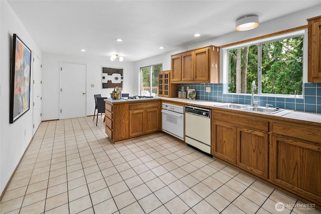 317NW 177th St, Shoreline, WA 98177 - kitchen featuring white appliances, tasteful backsplash, a peninsula, brown cabinetry, and recessed lighting