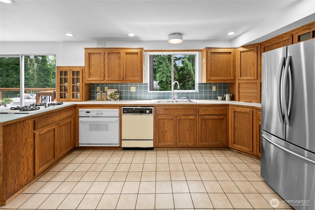 317NW 177th St, Shoreline, WA 98177 - kitchen featuring white appliances, light countertops, healthy amount of natural light, brown cabinets, and recessed lighting