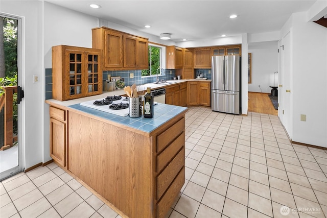 317NW 177th St, Shoreline, WA 98177 - kitchen featuring white appliances, tile counters, light tile patterned floors, decorative backsplash, and a peninsula