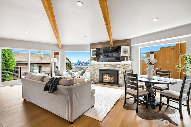 3406 SW Manning St, Seattle, WA 98126 - living room with a stone fireplace, beam ceiling, wood-type flooring, and recessed lighting