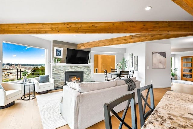 3406 SW Manning St, Seattle, WA 98126 - living room featuring beam ceiling, a glass covered fireplace, recessed lighting, and light wood-style flooring