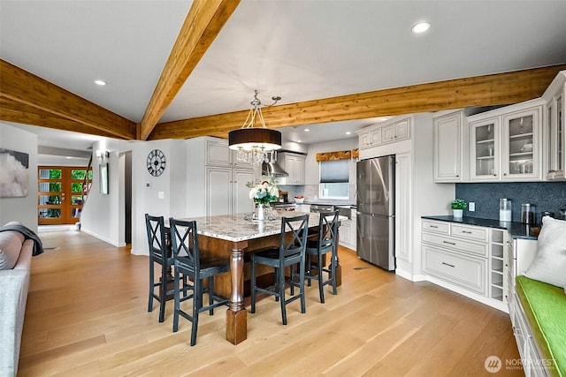3406 SW Manning St, Seattle, WA 98126 - dining area with light wood-type flooring, recessed lighting, and beam ceiling
