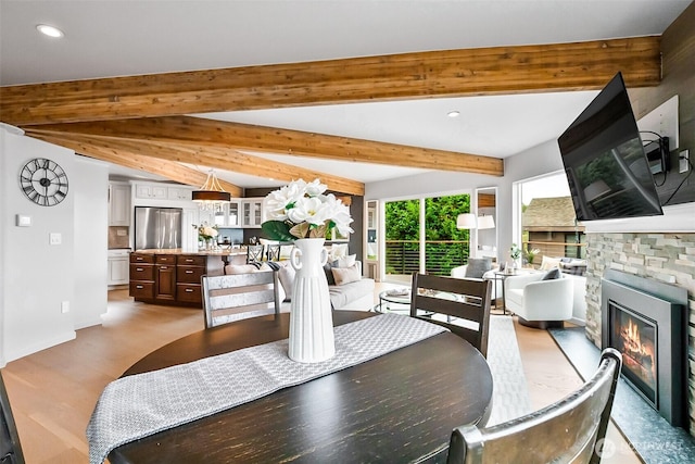 3406 SW Manning St, Seattle, WA 98126 - dining area featuring a fireplace, recessed lighting, wood finished floors, and beam ceiling