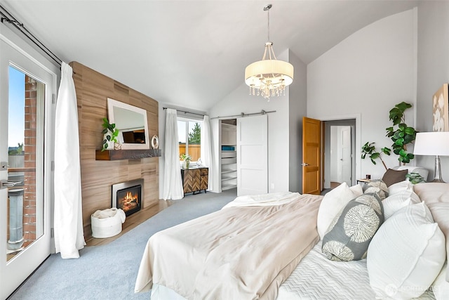3406 SW Manning St, Seattle, WA 98126 - carpeted bedroom featuring a barn door, vaulted ceiling, a large fireplace, and a chandelier